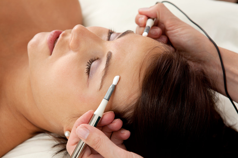 A woman having cosmetic acupuncture procedure